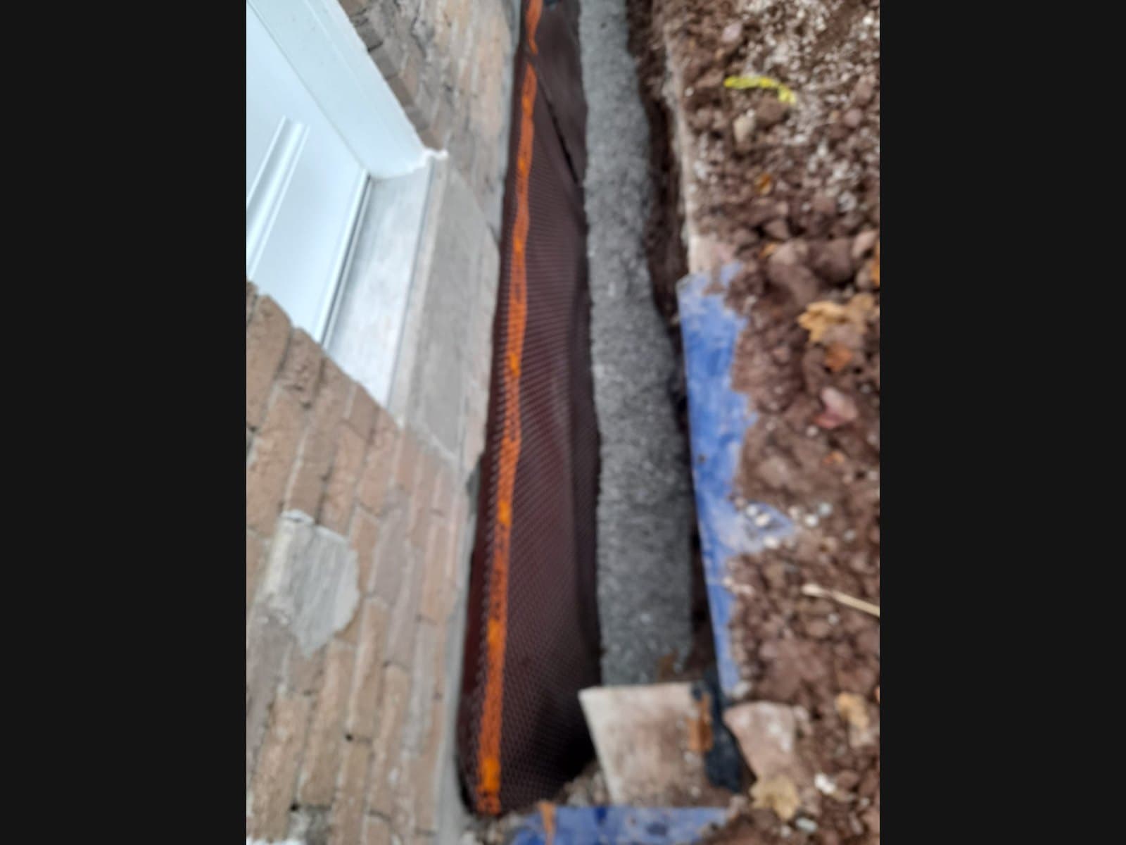 Interior dimpled membrane and drain in an Orillia basement