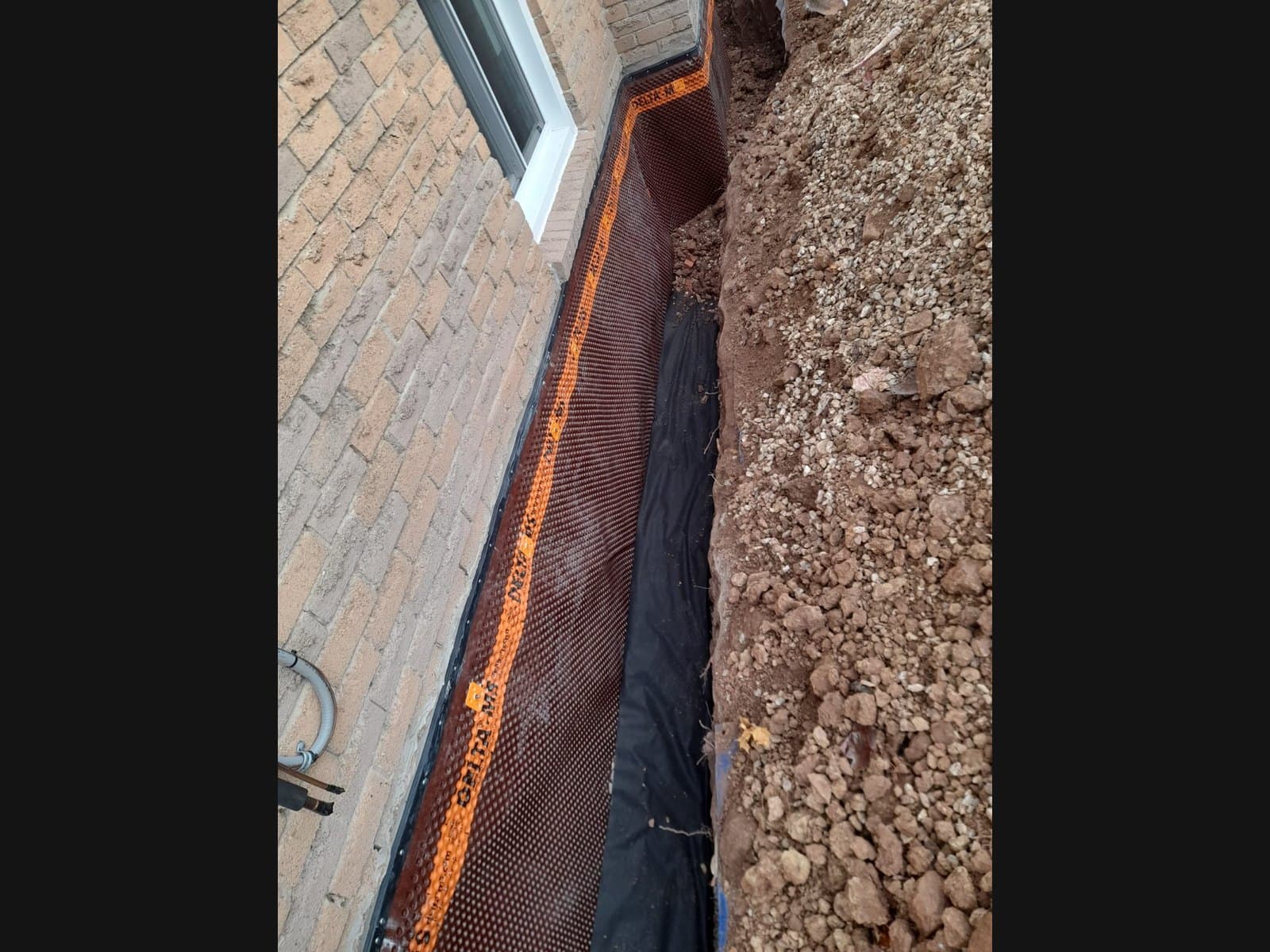 Basement Waterproofing Orillia crew work in a foundation trench