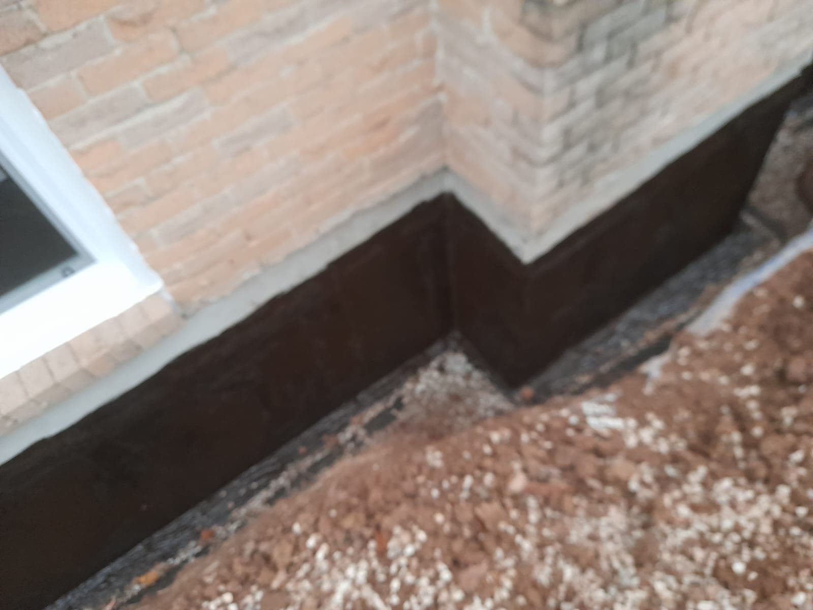 Weeping tile in drainage stone along an Orillia foundation